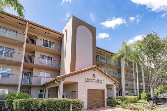 Front view of a multi-story residential building with balconies.