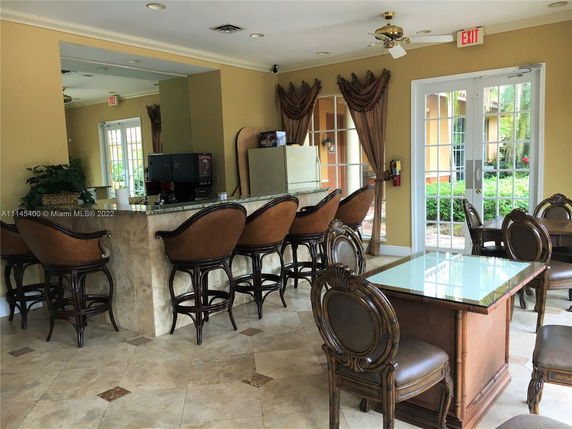 Interior view of a clubhouse with a bar and seating area.