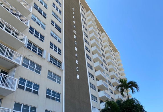 Front view of a multi-story building with balconies.