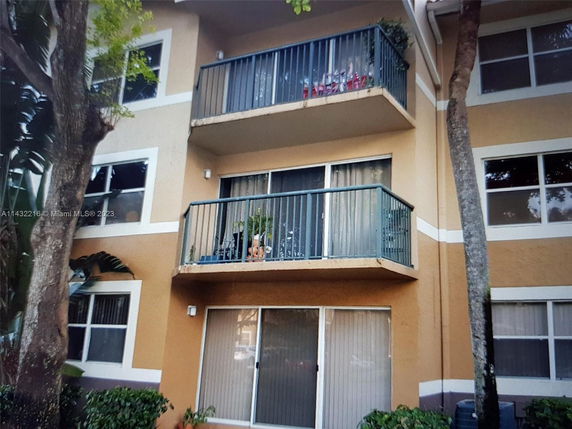 Front view of a multi-story building with balconies and windows.