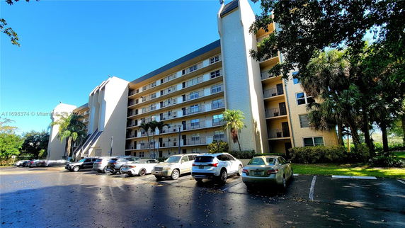 Front view of a multi-story apartment building with balconies.