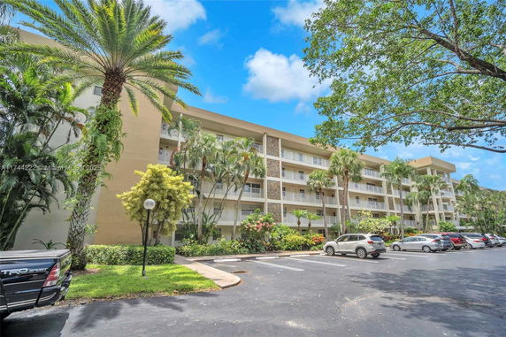 Front view of a multi-story residential building with balconies.