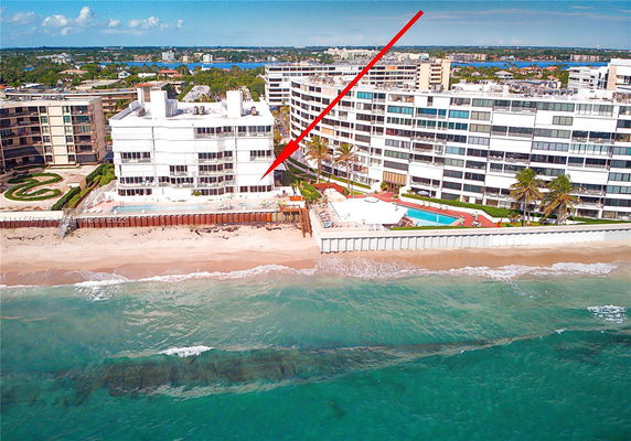 Aerial view of beachfront residential buildings.
