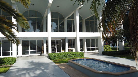 Front view of a building with large windows and columns.
