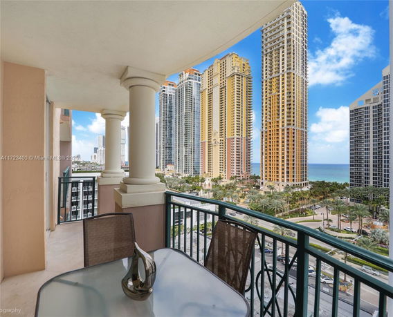 Balcony view of modern high-rise buildings near the coastline.