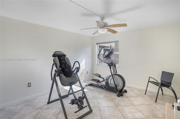 Room with exercise equipment including an inversion table and an elliptical machine.