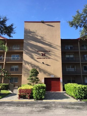 Front view of a multi-story apartment building with balconies.