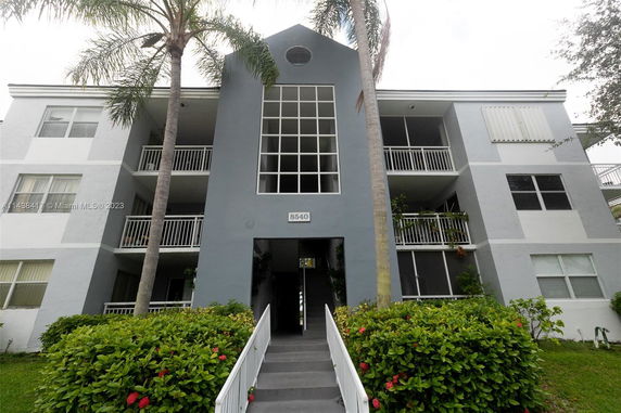 Front view of a multi-story residential building with balconies.