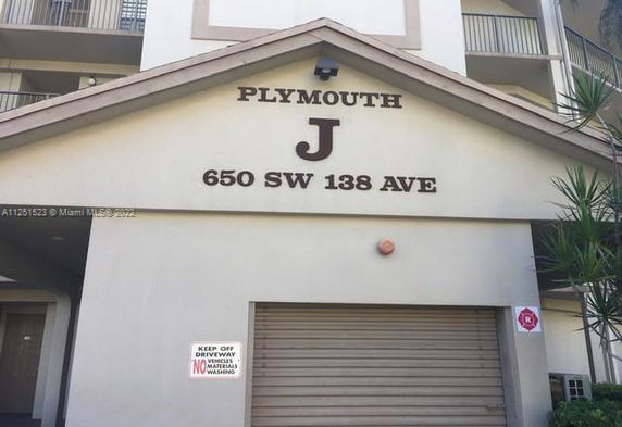 Front view of a multi-story building with labeled garage entrance.