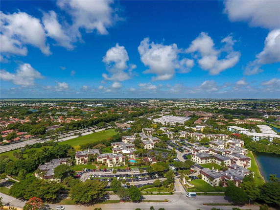 Panoramic view of a residential area with multiple buildings and a clear blue sky.