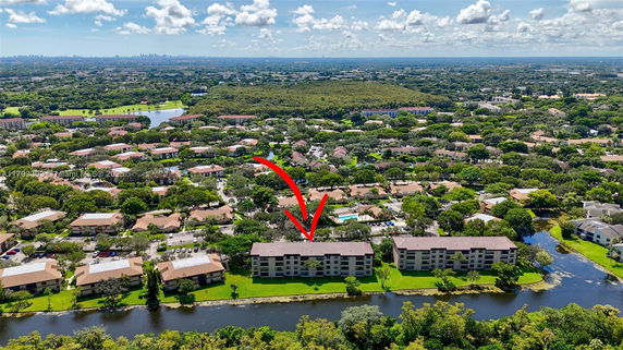 Aerial view of residential area with an arrow pointing to a specific building.