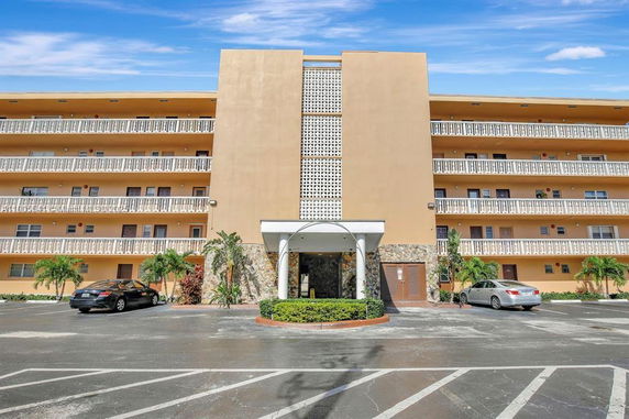 Front view of a multi-story residential building with balconies.