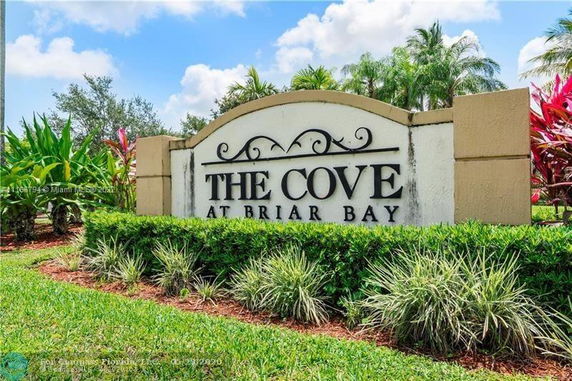 Entrance sign for 'The Cove at Briar Bay' surrounded by landscaping.