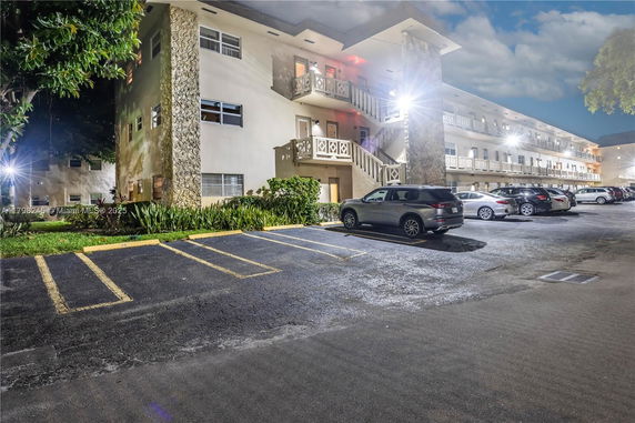 Outdoor parking area adjacent to a multi-story building.