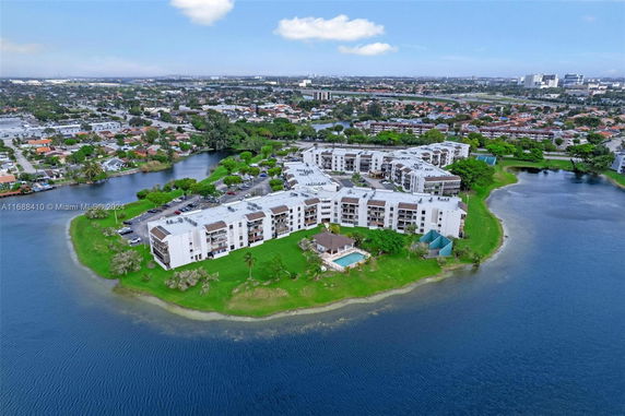 Aerial view of a residential complex surrounded by water.