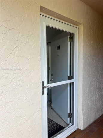 Entrance door of a residential apartment labeled with the number 104.