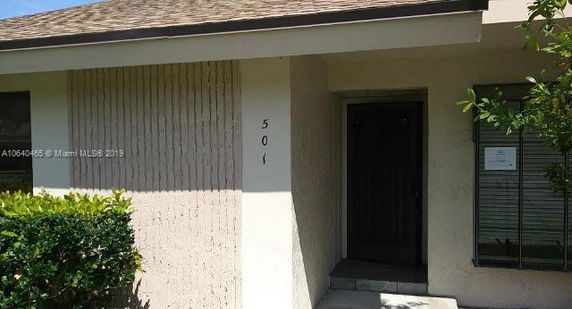 Front view of a house with a small entrance porch.