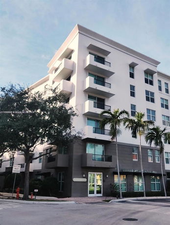Front view of a multi-story building with balconies.