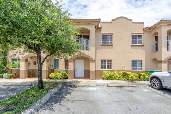 Front view of a two-story townhouse with balconies.