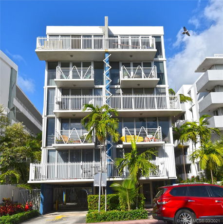 Front view of a multi-story residential building with balconies.