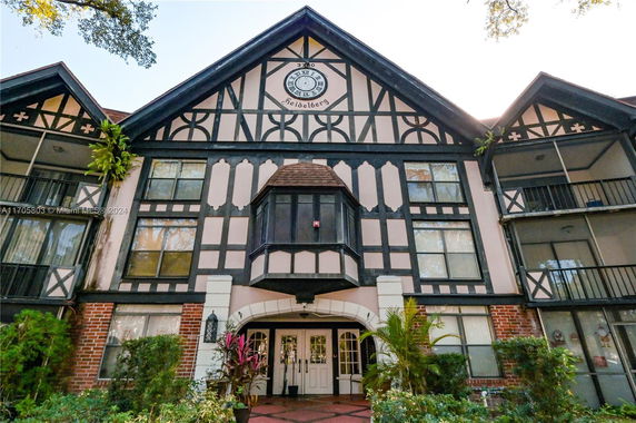 Front view of a multi-story building with a Tudor architectural style.
