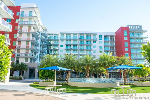 Front view of a multi-story residential building with balconies.