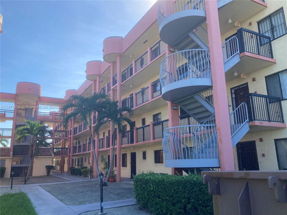 Front view of a multi-story building with spiral staircases.