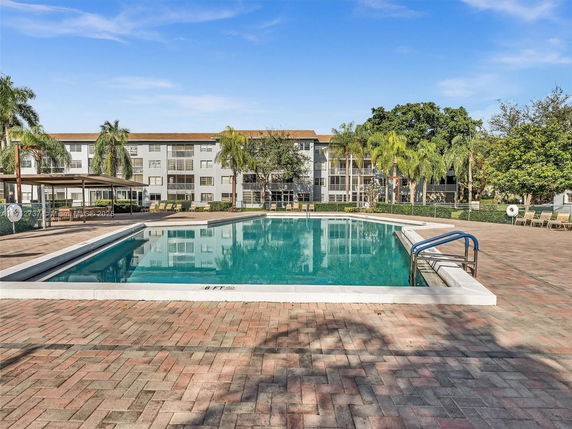 Swimming pool area in front of an apartment building.