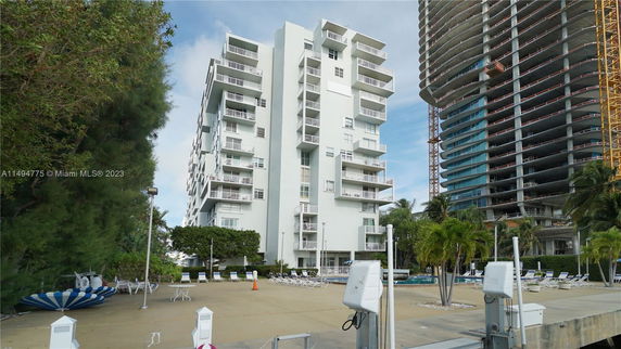 Front view of a multi-story residential building with balconies.