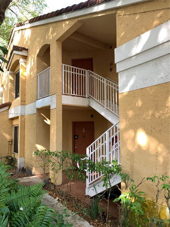 Front view of a two-story building with a staircase.