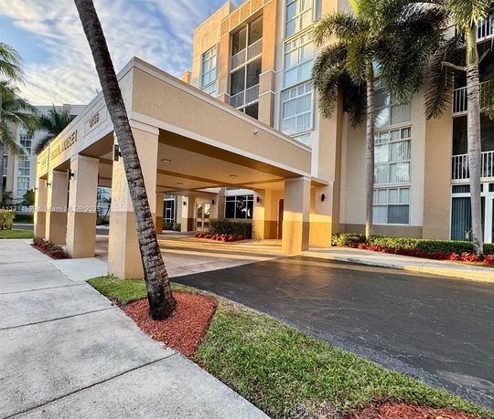Front view of a multi-story building with an entrance canopy.