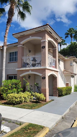 Front view of a two-story house with balconies.