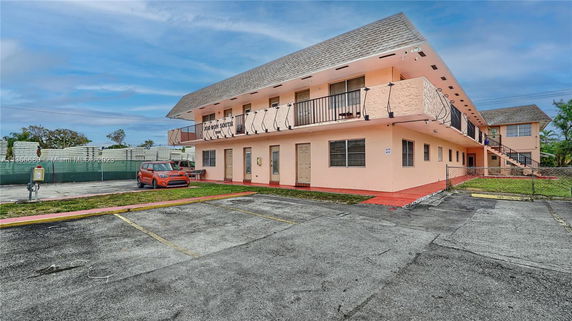 Front view of a two-story building with balconies.