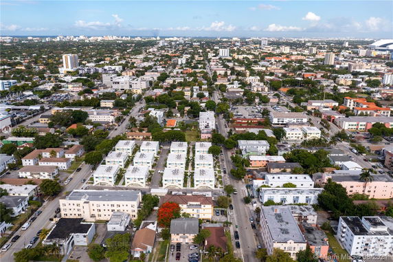 Aerial panoramic view of a city with numerous residential buildings and roads.