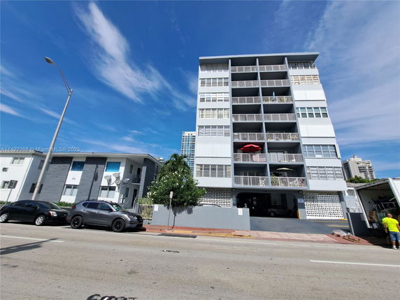 Front view of a multi-story residential building with balconies.