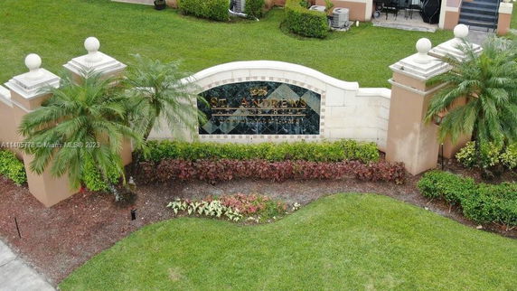 Entrance sign of a residential community with landscaping.