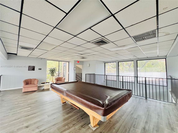 Indoor recreation area with a billiards table and seating.