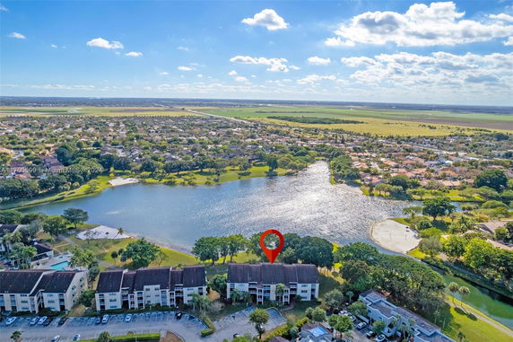 Panoramic view of residential buildings near a lake with expansive surroundings.