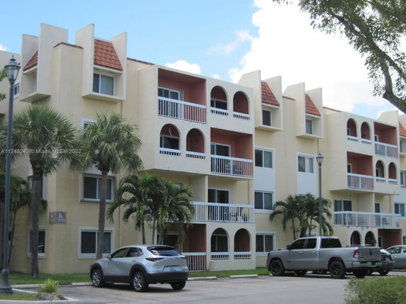 Front view of a multi-story residential building with balconies.