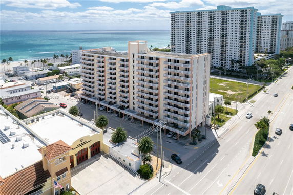 Front view of a mid-rise apartment building near the beach.