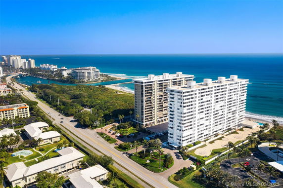 Aerial view of a seaside cityscape with several high-rise buildings near the ocean.