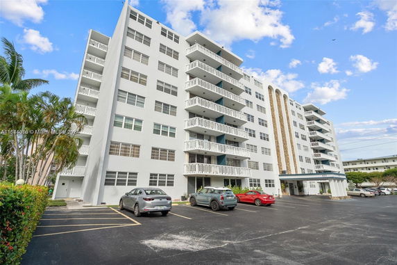 Front view of a multi-story residential building with balconies.