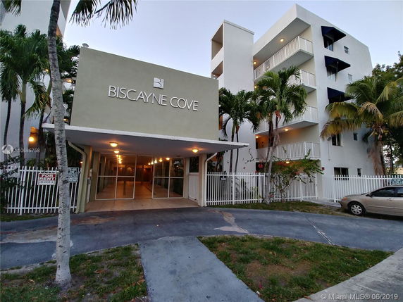 Front view of a multi-story apartment building named Biscayne Cove.