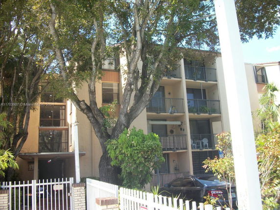 View of a multi-story residential building with balconies.