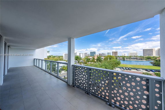 View from a balcony overlooking a cityscape and body of water.