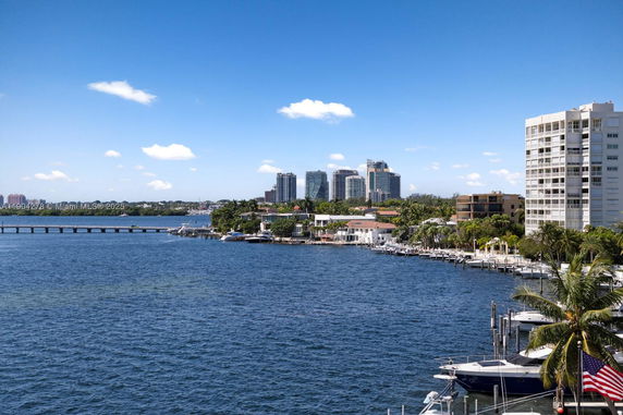 Panoramic view of a waterfront area with buildings and a marina.