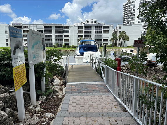 Buildings and a dock with a boat in a waterfront area