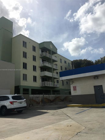 Front view of a multi-story residential building with balconies.