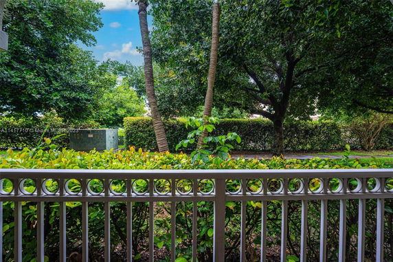 View from a railing showing lush greenery and trees.