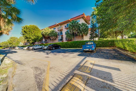 Outdoor parking area in front of a multi-story building.